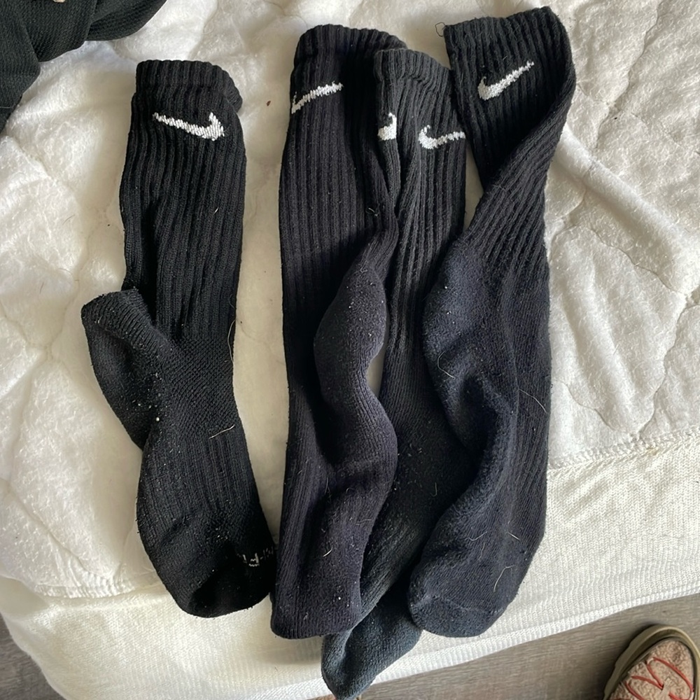 Two pairs used misc black Nike mid calves